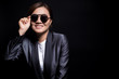 © chajamp - Happy businesswoman wearing sun glasses on isolated background