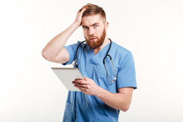 Portrait of a surprised young doctor in blue uniform