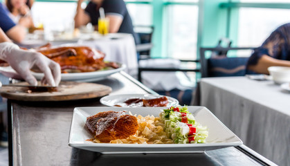 Chefs are making peking duck to serve customers.