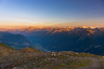 Wall Mural - Warm light at sunrise on mountain peaks, ridges and valleys