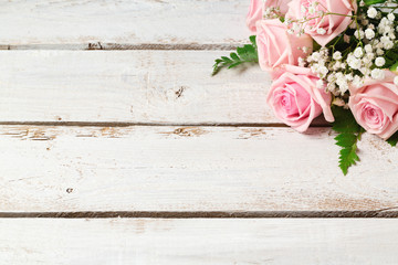 Background with rose flowers bouquet on wooden vintage table