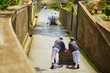 © Ekaterina Pokrovsky - Toboggan riders pushing wooden sledge downhill in Funchal, Madeira island, Portugal