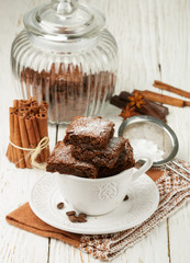 Wall Mural - Squares brownie in a white Cup. Chocolate dessert. Traditional dish of American cuisine. Selective focus