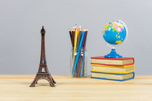 Eiffel Tower Statue And Stack Of Book ,color Pencil And Globe On The School Desk,knowledge School Background Education Concept