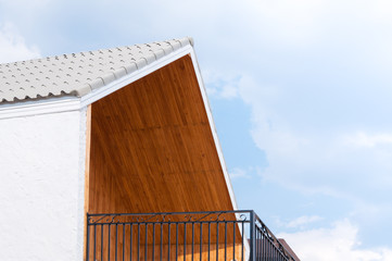 Wooden gabled roof with blue sky,triangles roof house sky background