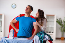 Super Hero Man Husband Ironing At Home Helping His Wife