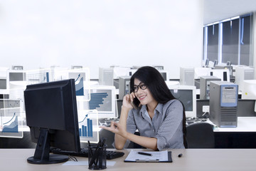 Wall Mural - Female worker talks growth charts by phone