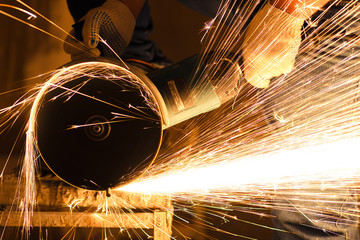  Industry worker cutting metal with grinder