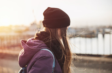 Wall Mural - Hipster girl walking on the bridge at sunset