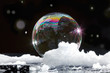 © Jill Greer - Ice bubble with rainbow colors floating in snow