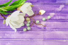 A Silk Magnolia Branch On A Purple Background With Spa Items