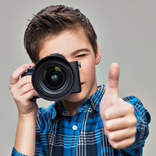 Boy With Photo Camera Taking Pictures.
