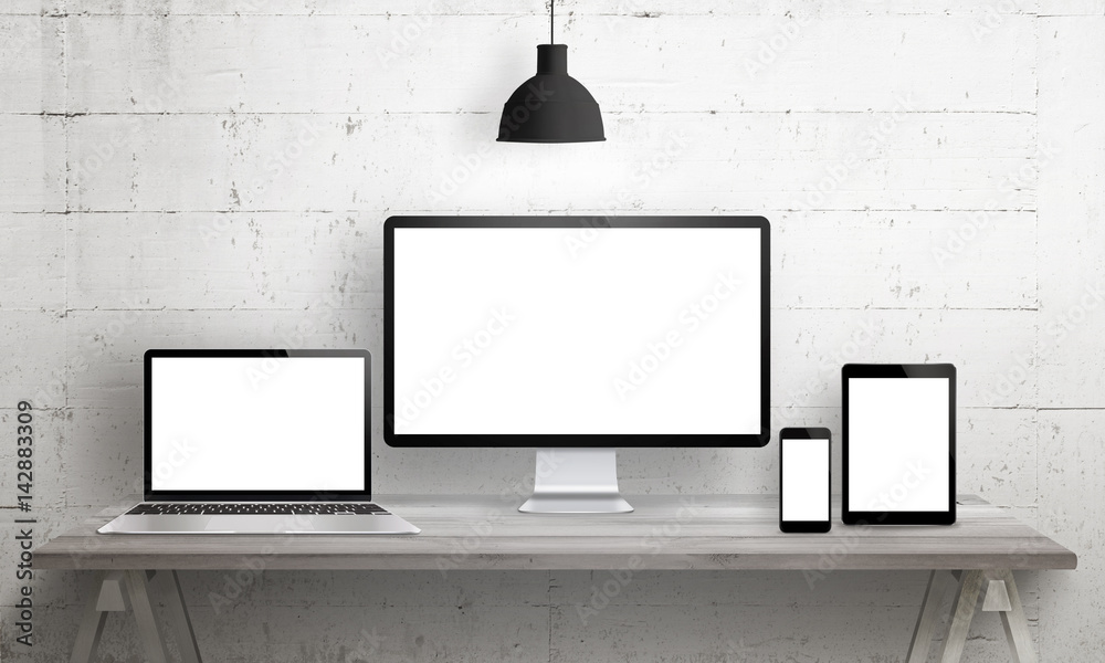 Responsive web site mockup. Computer display, laptop, tablet and smart phone on desk with isolated, blank, white screen for design presentation. - obrazy, fototapety, plakaty 
