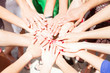 © nullplus - Large Group Of Young People Putting Their Hands Together
