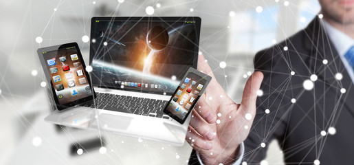 Poster - Businessman touching laptop phone and tablet with his finger 3D rendering