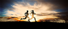 Young Couple Run Together On A Sunset