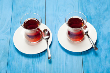 Cups of tea on a blue wooden background