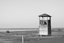 Old Tower For Lifeguards On The Deserted Beach In Black And White