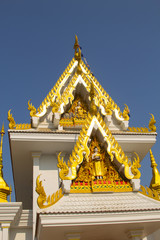 Wall Mural - Delicate Thai art at front facade of Buddhist church building at Wat Ton Chumsaeng Temple. Phichit, Thailand.