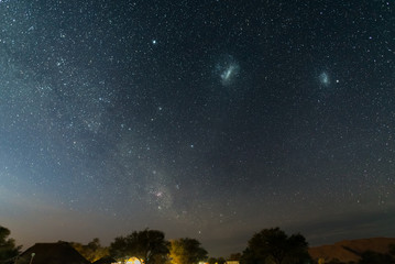 Wall Mural - the starry sky and the majestic magellanic clouds, outstandingly bright, captured in africa. acacia 