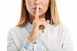 © Kalim - Adult woman holding a finger on her lips over white background