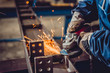 © kerkezz - Worker Using Angle Grinder