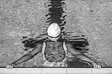 Wall Mural - Rear view of female swimmer on poolside