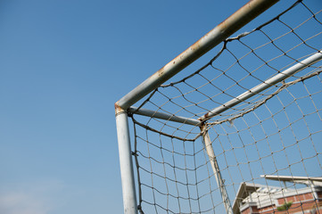 Wall Mural - soccer goal against blue sky background.