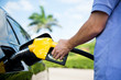 © xy - Hand refilling the car with fuel.