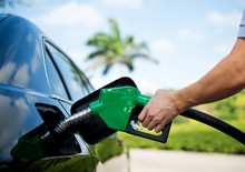 Hand Refilling The Car With Fuel.