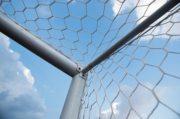 Wall Mural - soccer goal against cloudy sky background..