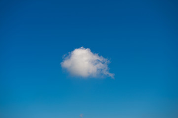 single white cloud against the blue sky..