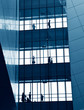 © xy - silhouettes of business people rushing at morden office building.