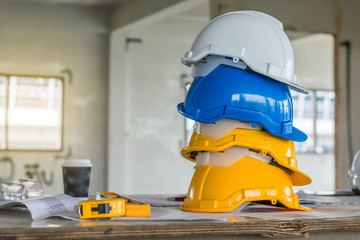 The safety helmet and the blueprint at construction site