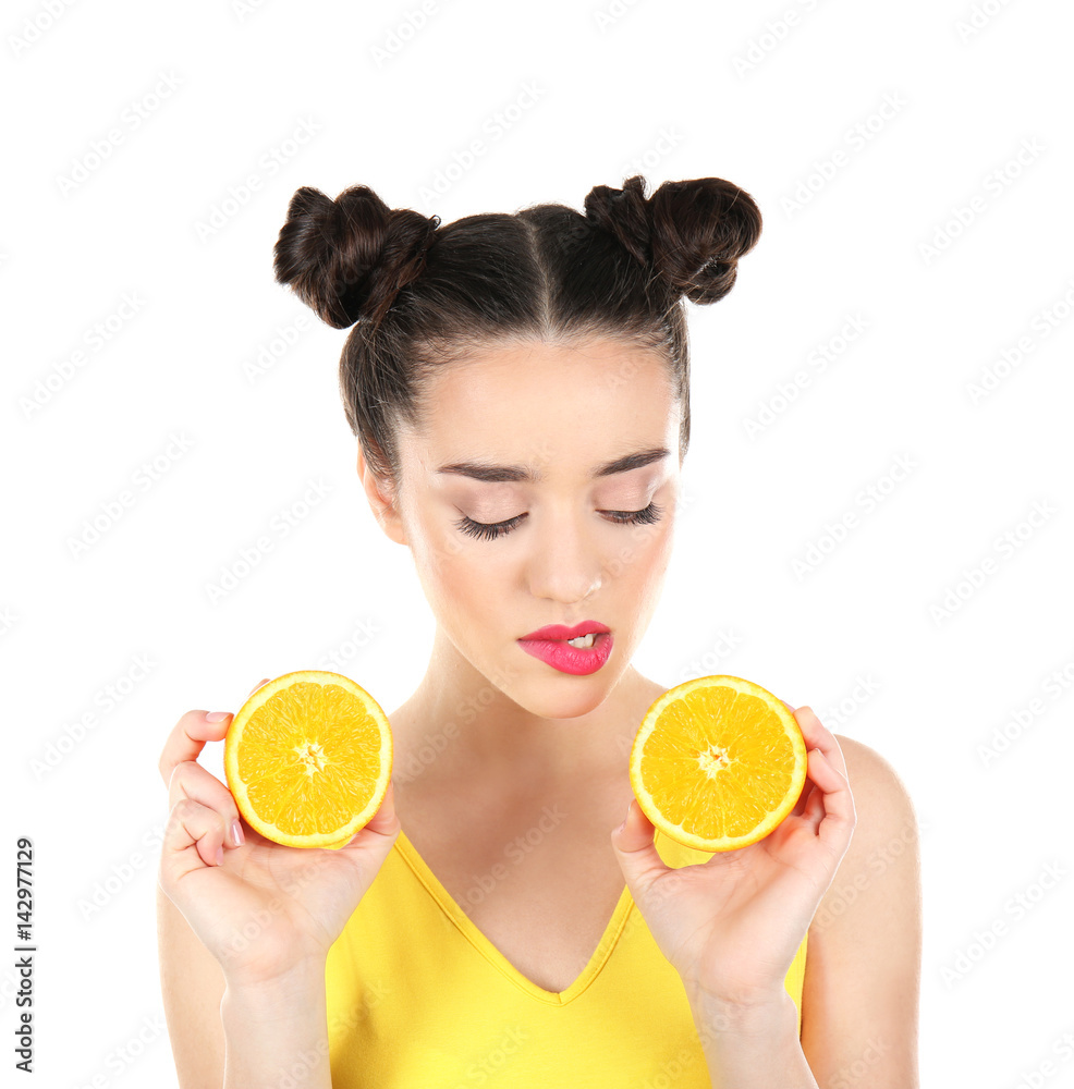 Beautiful young woman with orange on white background