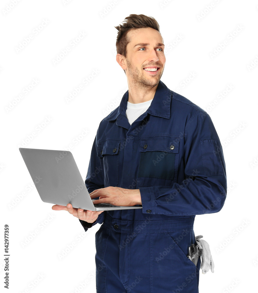 Handsome auto mechanic with laptop on white background
