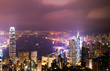 © xy - Hong Kong cityscape at night with victoria harbour and large group of tall buildings.