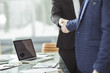 © yurolaitsalbert - success concept in business - handshake of business partners on the background of the workplace
