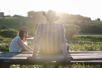 a couple of young people admire the sunset in the spring evening