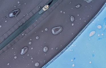 Detailed view of  softshell jacket with water drops, zipper and seams.