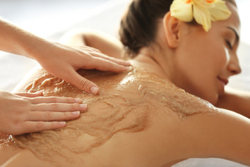 Poster - Young woman receiving scrub massage in spa salon