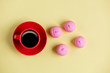 photo of tasty pink marshmallows and cup of coffee on the wonderful yellow background