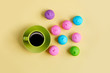 photo of tasty colorful marshmallows and cup of coffee on the wonderful yellow background