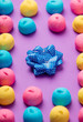 photo of tasty colorful marshmallows and dotted bow on the wonderful purple background