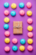 photo of tasty colorful marshmallows and cute gift on the wonderful purple background