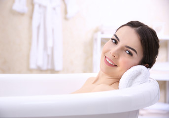 Canvas Print - Beautiful young woman taking bath at home