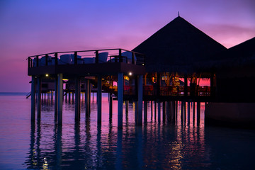 Wall Mural - silhouette of water bungalows at twilight, beautiful landscape