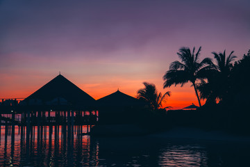 Wall Mural - silhouette of water bungalows at twilight, beautiful landscape