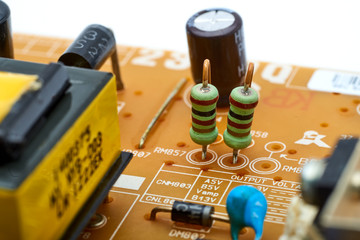 Resistors, capacitors and other electronic components of micro chip inside the computer close up