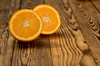 Taste the color. Shot of a halved orange on a wooden table.